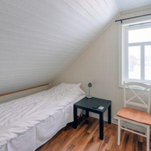 Interior bedroom roof tilted with curtain window